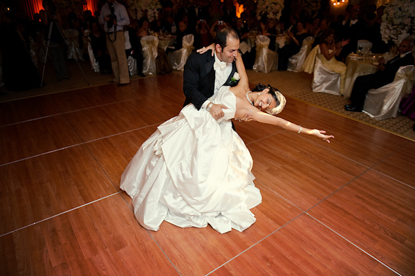 groom dipping his bride after their first dance at the reception